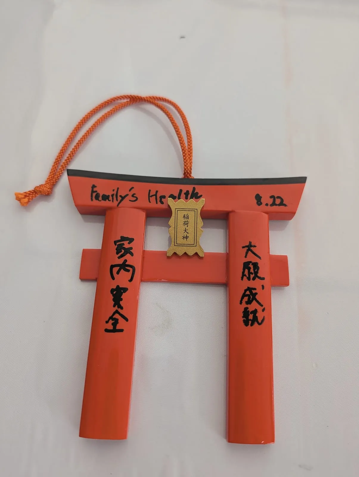 A torii-shaped ema written with Family's Health and two Japanese wishes, at Fushimi Inari, August 22, 2026